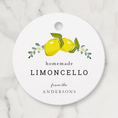 a white ornament with two lemons on it that says, homemade limoonocello from the andersons