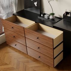 a wooden dresser with drawers in front of a window next to a vase and mirror