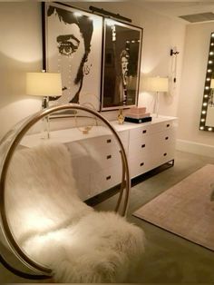 a bedroom with a bed, dresser and mirror on it's side wall next to a white rug