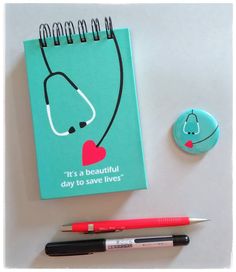 a notepad with a stethoscope on it next to a pen and marker