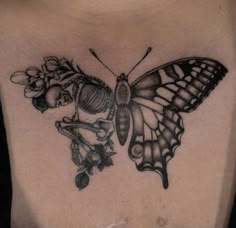 a black and white photo of a butterfly with flowers on it's back shoulder