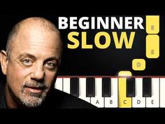 a man standing in front of a piano with the words beginner slow on it