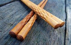 two wooden chopsticks sitting on top of a table