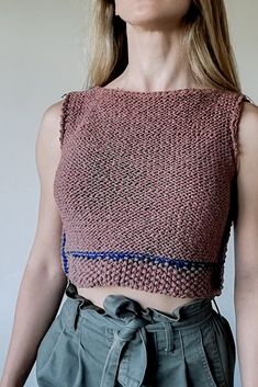 a woman with blonde hair wearing a crop top