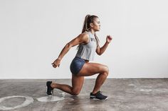 a woman is running on the cement floor