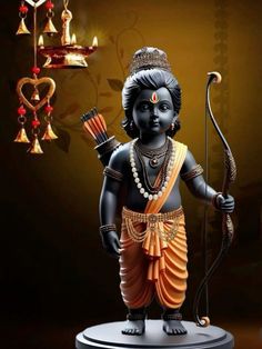 a statue of a hindu god holding a bow and an arrow in his hand, on a dark background