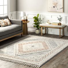 a living room with two couches and a rug on top of the wooden floor