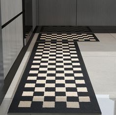 a black and white checkered rug is on the floor