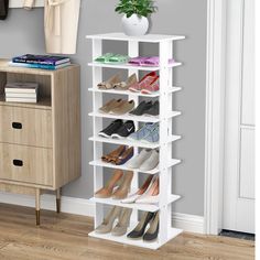 a white shoe rack sitting on top of a wooden floor