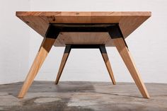 a wooden table sitting on top of a cement floor