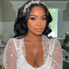 a close up of a person wearing a dress and headpiece with flowers on it