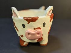 a small ceramic cow is sitting on the table