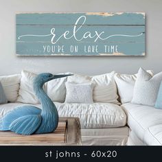 a white couch sitting next to a wooden sign that says relax you're on leave time