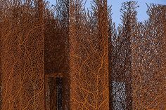 several tall metal sculptures sitting next to each other