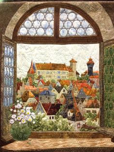 an image of a window with a view of the city and flowers in front of it