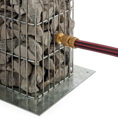 a large pile of rocks in a metal cage with a hammer sticking out of it