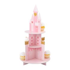 a pink castle shaped shelf with cupcakes on it