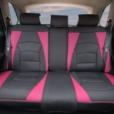 pink and black car seat covers in the back of a vehicle with two front seats facing each other