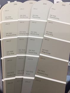 several shades of gray and white paint on display