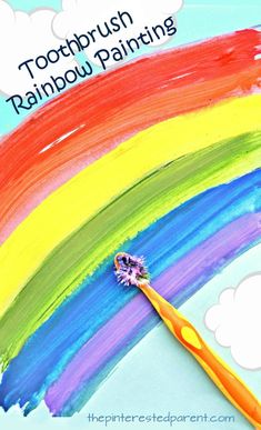 a toothbrush sitting on top of a rainbow painted background with the words, toothbrush rainbow painting