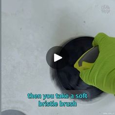 a person in green gloves is cleaning a sink