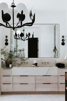 a bathroom with a vanity, mirror and lights