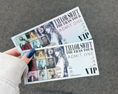 someone holding up two tickets for taylor swift concert