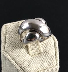 This is a lovely estate sterling silver statement ring featuring a modernist, abstract geometric domed cross over design. There is a partial 925 hallmark on the inner side of the band and the ring tests positive for sterling silver with the 18K acid solution - a video of testing is available upon request. Weight: 4.92 g Size: 4 ¾ - please check the ring on mandrel photo Width: 0.6" (1.5 cm) Good pre-owned condition with minor abrasions from previous wear; please see photos and video. A precious metal polishing cloth is included. All jewelry is sold in used, pre-owned condition. Vintage and antique items are expected to have some wear, imperfections, abrasions, scuffs, signs of use and age. Please look carefully at the photos; they are part of the item description. Some images may be consid Black Patch, Statement Ring Silver, Pretty Gift, Geometric Abstract, Antique Items, Statement Ring, Rings Statement, Precious Metals, Sterling Silver Jewelry