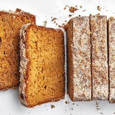 four slices of cake sitting next to each other on top of a white countertop