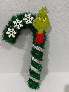 a grin face decoration on top of a candy cane