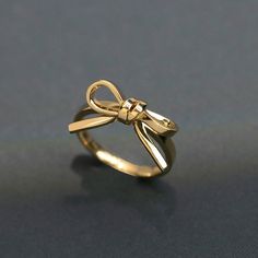 "Handmade Romantic 925 Sterling Silver Knot Bow Tie Ring, Dainty Ribbon Ring, Minimalist Band, Everyday Stacking Ring, Tiny bow Ring, Gift for Her, Bow Jewelry,Women's ring 14K Gold Ring, Gold Bow Ring, Bow Tie Ring, Delicate Ring Gold, Real Gold Ring, Minimalist Ring Gold, Dainty Ring Gold, Rings For Her Style: Minimalist Metal: 925 Sterling Silver. 18K gold  Band Colora Gold  Metal: 925 Sterling Silver Ring Sizs: 4 to 14 US. *See \"Size Guide\"" خواتم خطوبة, Preppy Jewelry, Bow Ring, Jewelry Accessories Ideas, Dope Jewelry, Classy Jewelry, Jewelry Essentials, Jewelry Lookbook, Ear Cuffs