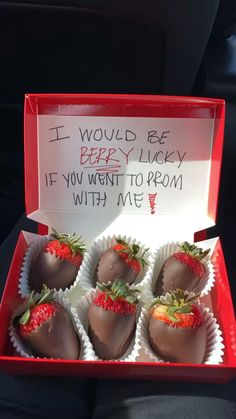 six chocolate covered strawberries in a red box with writing on the front and back