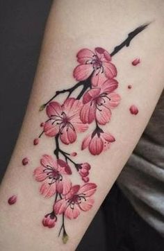 a woman's arm with pink flowers on it