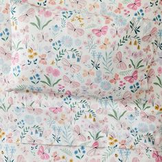 a pink and blue floral print sheet set with two pillow cases on top of each other