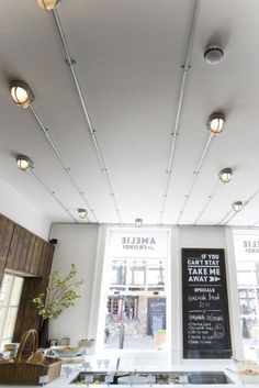 an empty restaurant with lots of lights on the ceiling