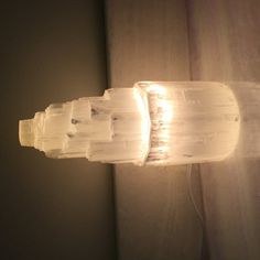 a light that is on the side of a wall next to a window sill