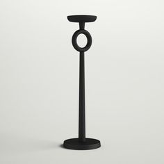 a black candle holder with an o - ring on the top is shown in front of a white background