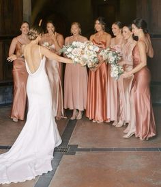 a bride and her bridal party posing for the camera