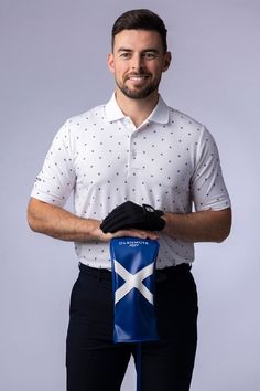 a man in white shirt holding a blue bag with a flag on it and black pants