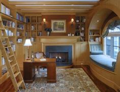 a living room filled with furniture and a fire place next to a book shelf full of books