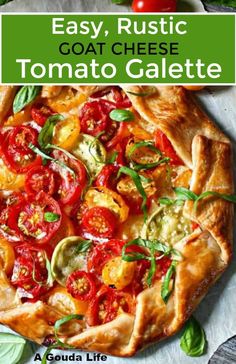 an easy, rustic goat cheese tomato galette with basil leaves and tomatoes on top