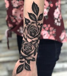 a black and white rose tattoo on the arm