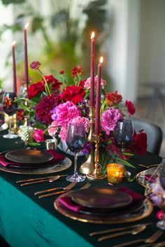 the table is set with candles and plates