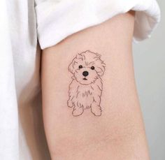 a small dog tattoo on the right side of the arm, with a black and white outline