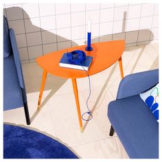 an orange table with a blue chair next to it