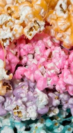 colorful popcorn kernels are stacked on top of each other in different colors and sizes