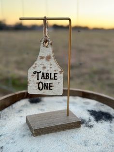 a wooden sign that says table one on it