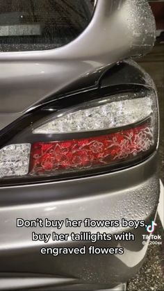 the back end of a silver car with a quote on it that says, don't buy her flowers boys