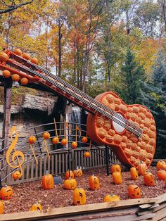 a musical instrument made out of pumpkins and music notes sits in the foreground