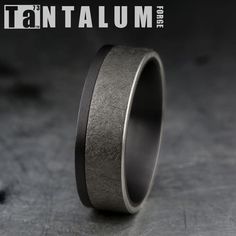 a wedding band that has been made to look like it is in black and silver